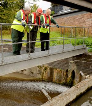 Environment Agency workers study the low level of the River Foss