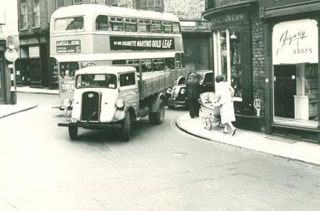 Whip-Ma-Whop-Ma-Gate believed to be between 1953 and 1955. The shop on the right that no longer exists was Joyway Shoes, The bus was a number 5 heading for Dosworth Avenue, and the truck was a vehicle owned by T. Belt & Sons Ltd, St. Maurice's Road, York