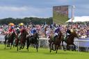 Japan, second right, ridden by Ryan Moore, wins the Juddmonte International Stakes ahead of Crystal Ocean, right, ridden by James Doyle, on day one of the Ebor Festival at York. Picture: Nigel French/PA Wire