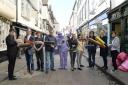 Traders from Stonegate in York, along with street performer Purpleman, take part in a clean-up of their street