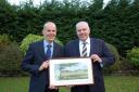 FIRM SUPPORT: Charles Walker (left) and Robert Woolley of HPH were presented with a watercolour painting by York Vale Cricket League chairman Shane Hargrave to celebrate 25 years of sponsorship from the firm