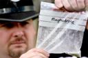 A police officer with a bag of mephedrone, also known as bubbles or meow, meow