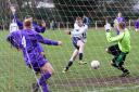 St Clement’s goalkeeper Matty Stables makes a point-blank save from Nestlé’s Kev Butler