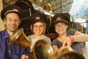 National Railway Museum staff, from left, Tim Procter, Ellen Tait and Anna Pinkstone prepare to “ring in” the Olympic celebrations