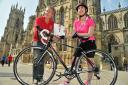 Phil McMahon, of the British Heart Foundation, hands the race number to heart transplant recipient Wendy Lingham who will be cycling in the Heart Of York 40-mile event