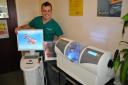 Dr Kris Leeson with the new CEREC machine which can create your crown or veneer on he spot