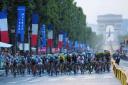 The Tour de France peloton makes its way along the Champs Elysees in Paris