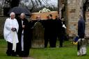 The coffin of Sir Marcus Worsley is carried from All Saints’ Church in  Hovingham on Saturday