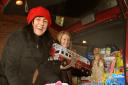 Corrina Dobson, left, and Sammy Price from the York Women’s Refuge load the toys donated by readers of The Press into their car before Christmas