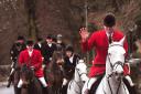 A huntsman waves as the Derwent Hunt hits the road at Thornton-le-Dale