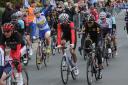 Sir Bradley Wiggins, centre, rides inside the peloton as it made its way along Westgate