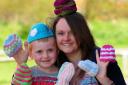 Lucy Hart and her son, Aston, with some of the many hats made by Lucy and volunteers