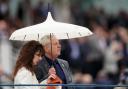 Racegoers shelter from the rain before the Sky Bet Race To The Ebor Jorvik Handicap during day one of the Dante Festival 2022 at York racecourse. Picture: PA