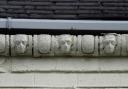 The mysterious stone faces on the gutters on the shop on the opposite corner of the road to Christine Waddington’s York Post Office in the 1990s