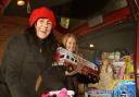 Corrina Dobson, left, and Sammy Price from the York Women’s Refuge load the toys donated by readers of The Press into their car before Christmas