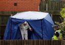 An officer leaves the forensic tent at Burnholme Grove today.