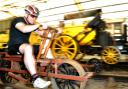John McGoldrick, associate curator of Museum Collection at the National Railway Museum, has a race with the Rocket on the museum’s velocipede ahead of their Grand Départ event