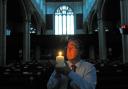 St Michael le Belfrey administrator Mark Rance lights a candle to mark the 100th anniversary of the start of the First World War