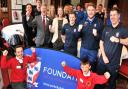 CHEERS: Burton Green pupils Kleo Falcone, left, and Kaiden Butler join York City chairman Jason McGill, Paula Stainton and staff at York City Foundation after they were given charitable status