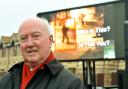 Peter Lawrence stands in front of the mobile screen showing the CCTV footage