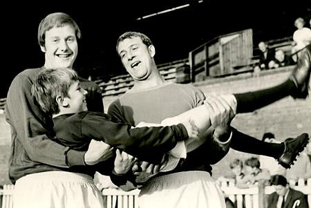 11/08/70: In safe hands - York City goalkeepers Gordon Morritt (right) and Mick Gadsby gather up City's new mascot, 11-year-old Keith Robinson.