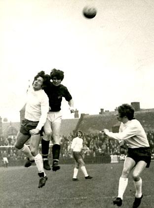 01/01/72 - York City 0, Bolton Wanderers 0: Yorkshire Evening Press photographer Jimmy Brownbill captures the moment Bolton full back Paul Hallows and City's Phil Burrows clash heads in a duel for the ball.