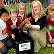 Ralph Butterfield Primary School head teacher Angela Mitchell holds one of the hens that pupils named in an election