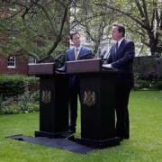 Prime Minister David Cameron and deputy Prime Minister Nick Clegg give their first press conference in the Downing Street garden