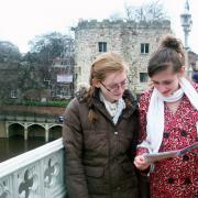 Pals Molly and Chloe study the treasure trail clues