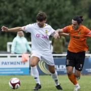 Tadcaster Albion midfielder Jordan Deacey battles for possession against Brighouse Town.