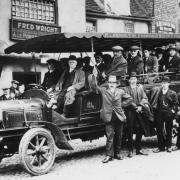 Archive picture from York Library of a charabanc trip leaving from the Black Swan Inn, Peasholme Green in 1910.  Landlord Fred Wright in foreground with trilby hat and hand on hip.