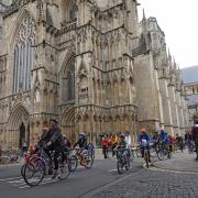 Cyclists pass York Minster during the ride