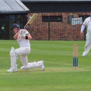 Year 11 pupil Alex playing cricket