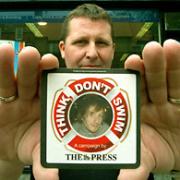 John Maughan, of Printer People, in Walmgate, with one of the Think, Don’t Swim beermats which are to be distributed in the city’s pubs and bars