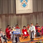 Kyle Ma held up a flag reading: “Liberate Hong Kong, revolution of our times” while onstage during his graduation from the University of York