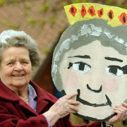 Mollie Haigh with a picture of the Queen painted by children at Forest of Galtres School, where she is a governor