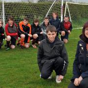 Olympic torch bearer Carol Newman and her son, Tom, with some of the players at Poppleton Junior FC