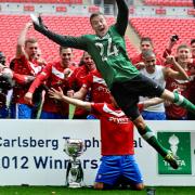 Goalkeeper Michael Ingham leads the after match celebrations after their win against Newport County