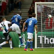 Italy's Mario Balotelli (centre) scores his side's first goal of the game