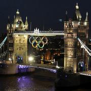 The Olympic rings are lit up on Tower Bridge, London, in preparation for the start of the 2012 London Olympics.  The rings were made by Stage One, based in Tockwith