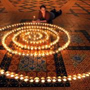 York Minster marketing assistant Katy Wood in the Chapter House with the spiral of lights which is eventually hoped to contain 800 candles