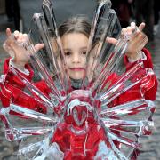 A youngster admires an ice sculpture at the Festival Of Angels, in Swinegate, York