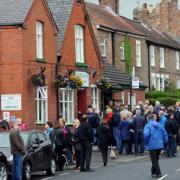 Villagers gather outside the Reading Rooms in Dunnington, which was already at capacity, for the  residents’ meeting about the proposed travellers’ site