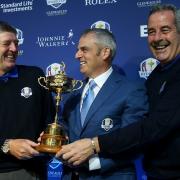 European Ryder Cup captain Paul McGinley, centre, bids to hang on to the trophy, aided by vice-captains Sam Torrance, right, and Des Smyth