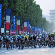The Tour de France peloton makes its way along the Champs Elysees in Paris