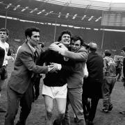 Library file dated 16/04/1967 of Scottish footballer Jim Baxter, enthusiastically being hugged by fans after Scotland beat England 3-2 at Wembley. The Scotland and Glasgow Rangers hero,  died from cancer at the age of 61, Saturday 14 April, 2001. See PA