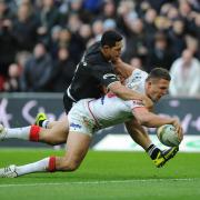 Flashback to last year’s World Cup semi-final against New Zealand, where England’s Sam Burgess scores a try under pressure from New Zealand’s Roger Tuivasa-Sheck