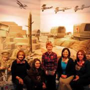 Choir members Linda James, Hazuki Mogan, Eleanor Cunnington, Shino Mogan and Victoria Dibbs pictured inside the Castle Museum's World War One Exhibition where they are to sing.