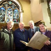 The Rev Rachel Hirst in the memorial chapel of St Peter's Church, Norton with (l-r) John Howard, Ron Wilson and Colin Jennings and the book listing the men and women killed during World War I.Picture: Richard Doughty Photography
