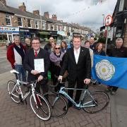 Preparing for the arrival of the Tour de Yorkshire are Gary Verity, chief executive of Welcome To Yorkshire, front right, and Johnny Hayes, front left, chairman of the Bishy Road Traders Association, with traders and residents from Bishopthorpe Road